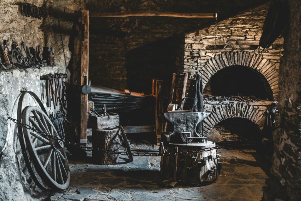 Old forge scene with furnace, anvil, and tools lining stone walls