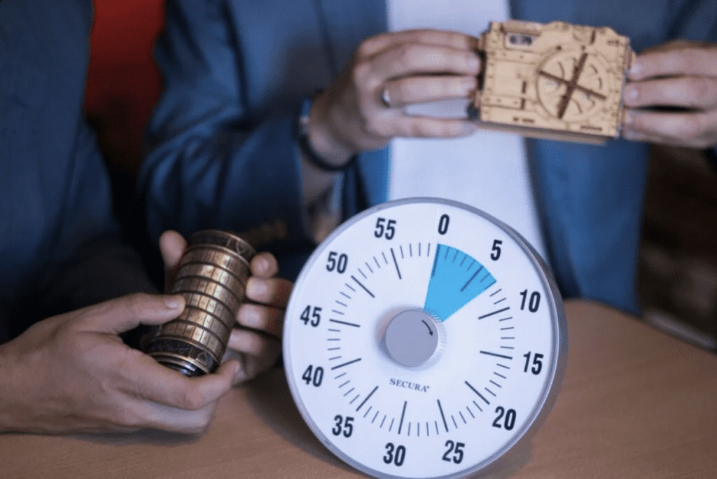 Two people solving puzzles with a timer during an escape room experience, one of the most exciting group activities Pittsburgh offers for friends, families, and team-building.